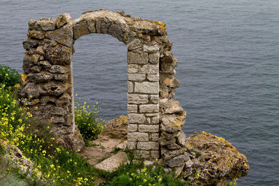 Stone wall with sea in background