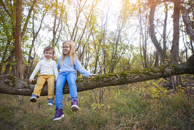 Full length of a smiling girl in forest