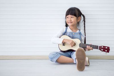 Portrait of a girl playing guitar
