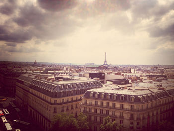 Cityscape against cloudy sky