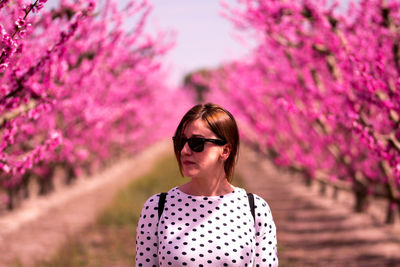 Portrait of woman with pink flower