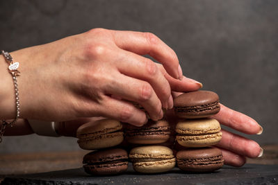 Close-up of person hand on stack of table