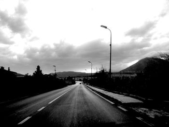 View of street against cloudy sky