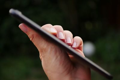 Close-up of hand holding mobile phone