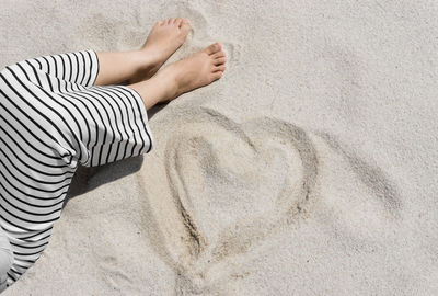 Woman lying on sand