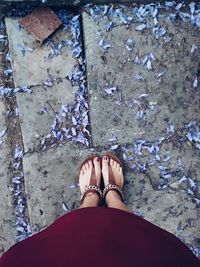 Low section of woman standing on tiled floor