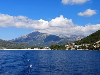 Scenic view of sea and mountains against sky