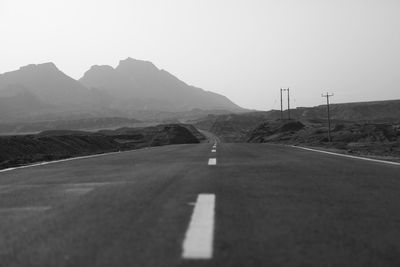 Empty road leading towards mountains