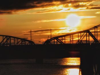 Silhouette bridge against sky during sunset