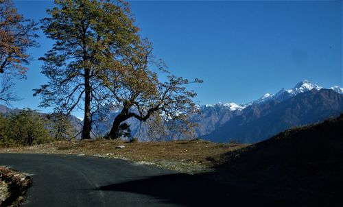 Scenic view of snowcapped mountains against clear blue sky