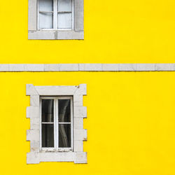 Low angle view of yellow window on building