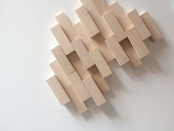 High angle view of wooden blocks against white background