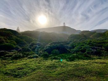 Scenic view of landscape against bright sun