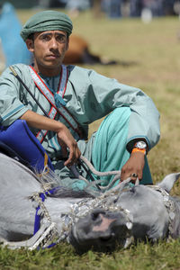 Portrait of young man sitting outdoors