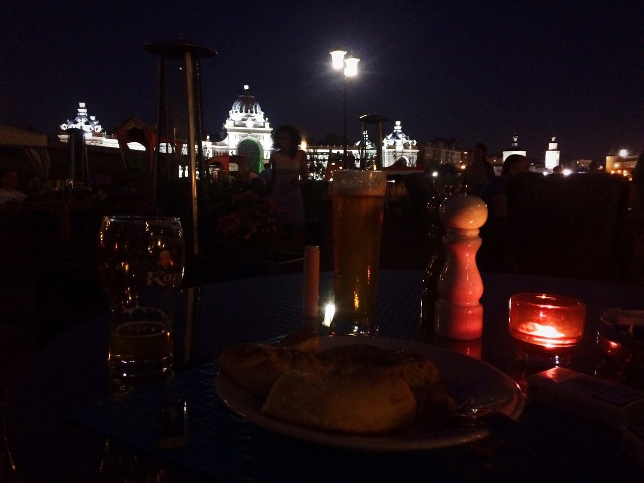 illuminated, night, city, building exterior, food and drink, architecture, built structure, lighting equipment, indoors, glowing, cityscape, dark, table, light - natural phenomenon, lit, sky, candle, glass - material