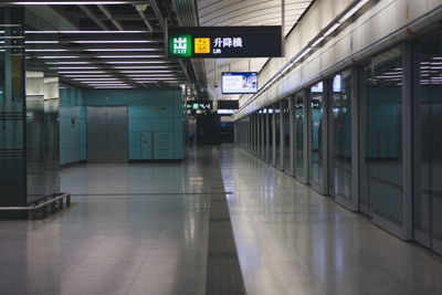 Interior of illuminated railroad station platform