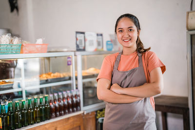 Portrait of young woman standing at home