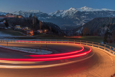 Light trails on road in city at night