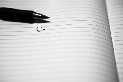 Pen and smiley face on book