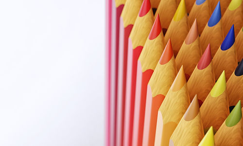 Close-up of colored pencils against white background