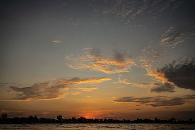 Scenic view of silhouette field against sky during sunset