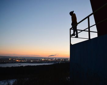 Silhouette man against clear sky during sunset