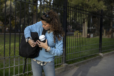 Side view of young woman photographing through camera