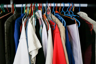 Various clothes hanging in rack