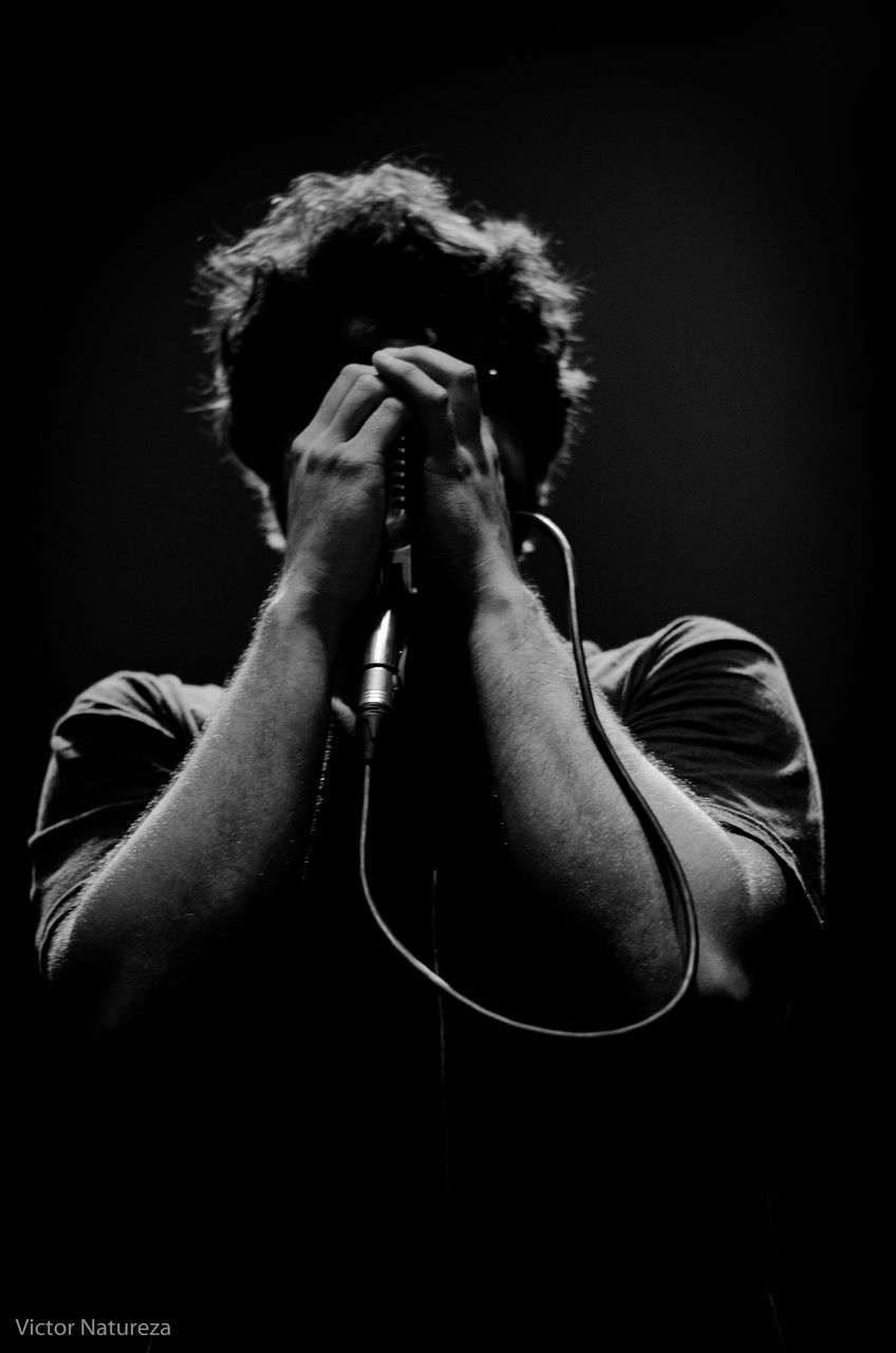 one person, one man only, studio shot, only men, adults only, performance, human body part, black background, adult, people, indoors