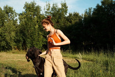Young woman with dog on field