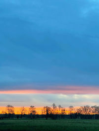 Scenic view of field against sky during sunset