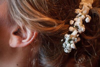 Cropped image of woman wearing flower on hair