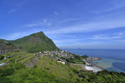 High angle view of sea and mountains against sky