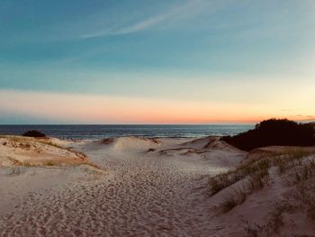 Scenic view of beach against sky during sunset