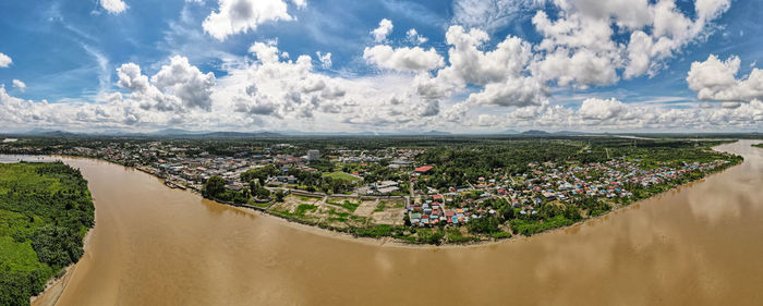 Panoramic shot of river flowing on land against sky