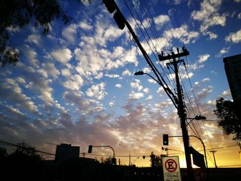 Low angle view of city against sky during sunset