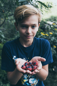 Portrait of boy holding apple