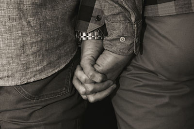 Midsection of man holding hands