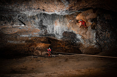 Man standing on rock in cave