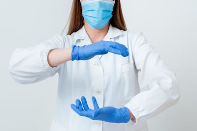 Midsection of woman wearing hat against white background