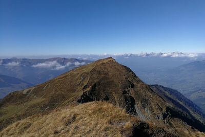 Scenic view of mountains against clear blue sky