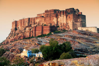 Low angle view of mehrangarh fort against clear sky during sunset