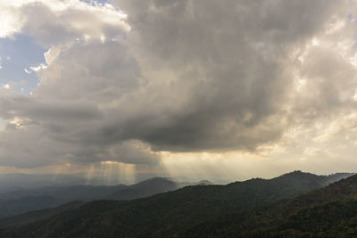 Scenic view of mountains against dramatic sky