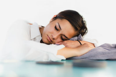 Young woman lying on bed at home