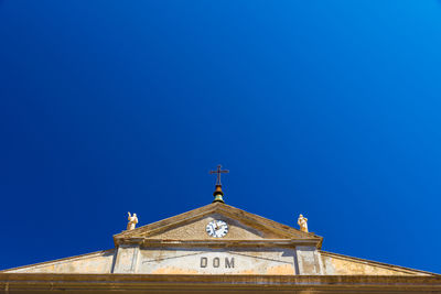 Low angle view of building against clear blue sky