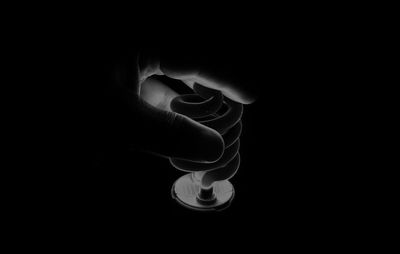Close-up of human hand against black background
