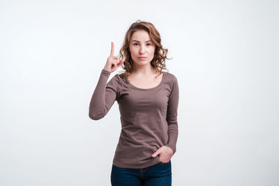 Portrait of smiling young woman against white background