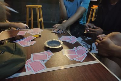 High angle view of people playing on table