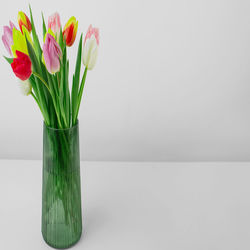 Close-up of vase on table against white background