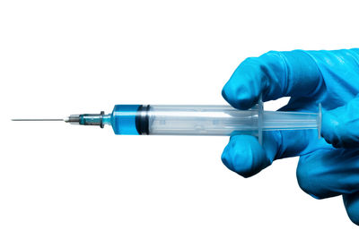 Midsection of person holding umbrella against white background